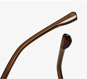Detail of amber tortoiseshell eyeglass temple tips with anti-slip textured grip