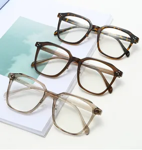 Detail view of retro oversized TR glasses frames in tortoise, amber, and champagne colors