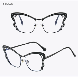 Detailed macro view of black butterfly wing shaped metal eyeglass frames with clear lenses