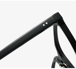 Detail of glossy black TR frame hinges with iconic silver double rivets and sleek design
