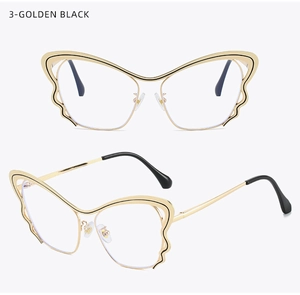 Detail of butterfly shaped golden and black metal glasses frame with wavy hollow design