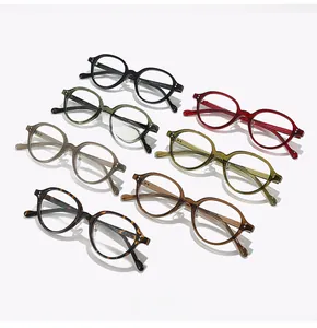 Flat lay of retro oval eyewear frames in seven assorted colors including tortoiseshell and grey