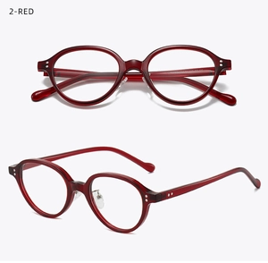Detail view of red oval glasses frame featuring silver rivet accents and translucent finish