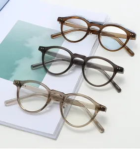 Detail view of TR90 round frames in amber, grey, and champagne with silver rivets