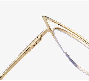 Detailed close-up of golden metal cat eye frame showing precision hinge and screw structure