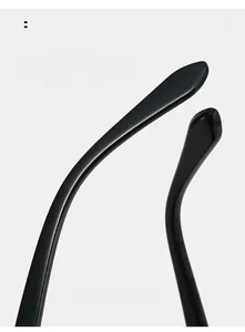 Macro detail of glossy black ergonomic curved temple arms for comfortable outdoor sports sunglasses