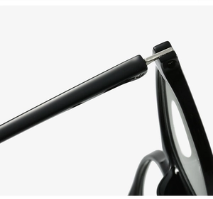 Macro shot of precise silver metal hinge on sleek black TR90 eyewear frames