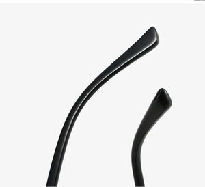 Detail of glossy black TR90 eyeglass temple tips with smooth ergonomic curved ends