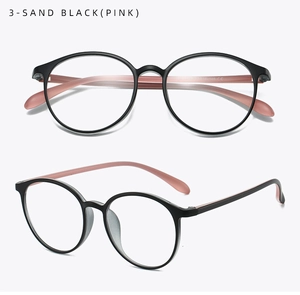Detail of round retro glasses in sand black with transparent pink temples