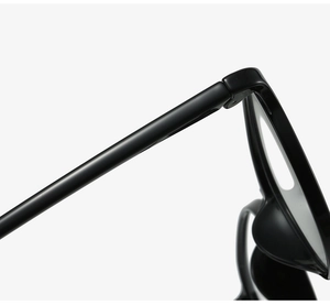 Detail of metal hinge and integrated nose pad on black TR90 round glasses frame