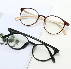 Classic round eyeglass frames in black and tortoise pattern shown in a minimal setting