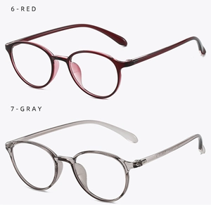 Detail view of round TR90 glasses frames in transparent red and gray with metal hinges