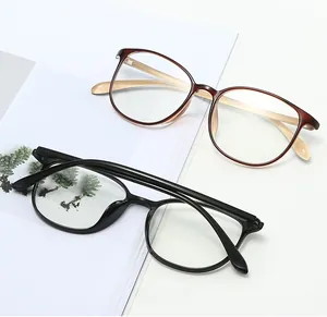 Detail of round TR90 anti-blue light glasses showing metal hinges and tortoise frame texture