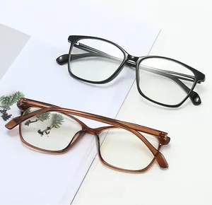 Detailed view of square TR eyeglasses frames in black and tea colors on a magazine
