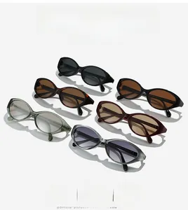 Six pairs of cat-eye sunglasses in various colors displayed with stylish hard shadows
