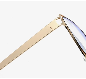 Macro view of gold metal hinges and black frame detail on trendy rectangle glasses