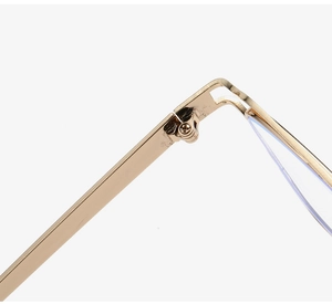 Macro detail of the reinforced gold metal hinge and precision screw on eyewear frame