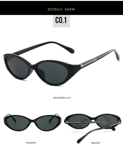 Detail view of glossy black cat-eye sunglasses with silver decorative temples and dark lenses