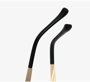 Detailed close-up of fashion eyewear temple tips with gold metal and black sleeve finish