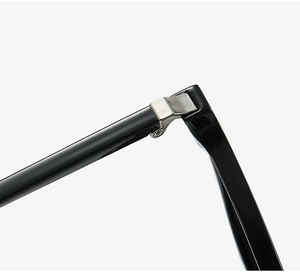 Macro detail of high-quality silver metal hinges on durable black TR90 eyewear frames