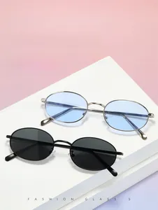 Detail of silver oval sunglasses with blue lenses and black retro metal eyewear
