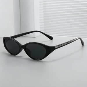 Chic black oval cat-eye sunglasses with detailed metal accents on a modern background