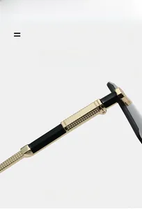 Detail of luxury gold metal hinges and black textured temples on rimless sunglasses