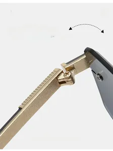 Detail of durable gold textured metal hinge for rimless sunglasses showing folding mechanism