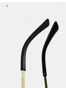 Detail of curved ergonomic sunglasses temples with golden grid texture for comfort