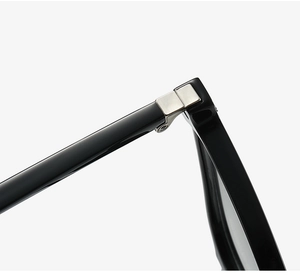 Detail view of reinforced silver metal hinges on professional black square glasses frame