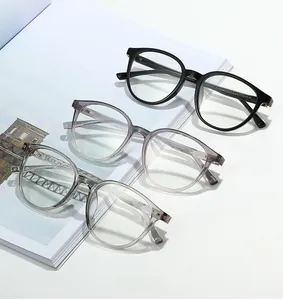 Close-up of three stylish round glasses frames in black, gradient grey, and clear colors