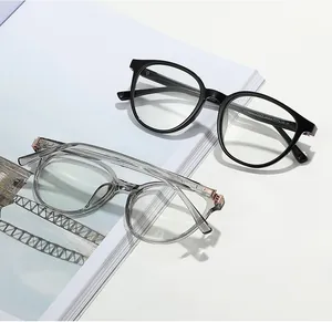 Detail of round retro glasses frames in black and grey with rose gold metal hinges