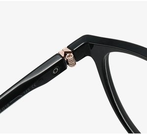 Macro detail of rose gold hinge and CE markings on black vintage round glasses frame