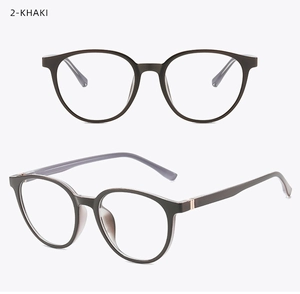 Detail of round khaki glasses frames with elegant gold metal accents and retro design
