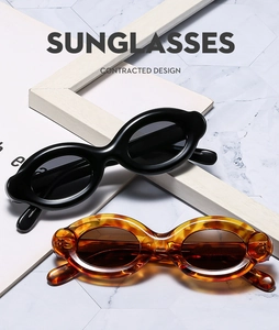Macro view of vintage oval sunglasses in classic black and tortoise shell finish