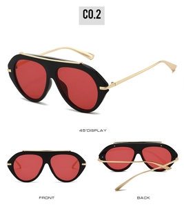 Detailed views of oversized aviator sunglasses with black frame, red lenses and gold metal