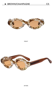 Macro view of vintage oval sunglasses in brown champagne frame with orange lenses