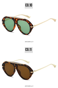 Detail of tortoise pilot sunglasses in forest green and brown lenses with gold metal accents