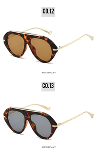 Detail view of oversized retro aviator sunglasses with tortoise frames and metal top bar