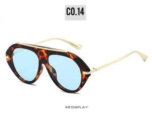 Detail of 70s retro tortoiseshell aviator sunglasses with gold top bar and blue lenses