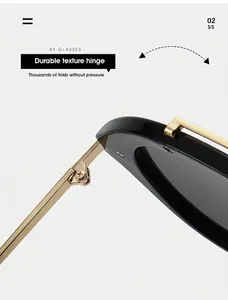 Λεπτομέρεια από τον χρυσό μεταλλικό μεντεσέ σε υπερμεγέθη γυαλιά ηλίου τύπου πιλότου