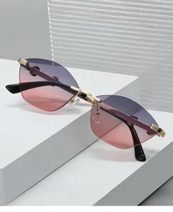 Detail of rimless cat-eye sunglasses with gradient purple lenses and gold metal frame