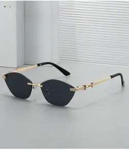 Detail of rimless cat-eye sunglasses with gold metal temples and jointed design