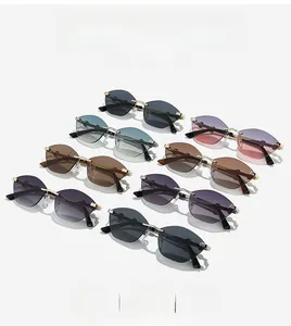 Detail view of various colored rimless cat-eye sunglasses with gold metal bridge