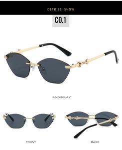 Detail view of rimless cat-eye sunglasses with gold metal chain temples and dark lenses