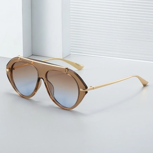 Oversized retro pilot sunglasses with gold metal trim and brown blue gradient lenses