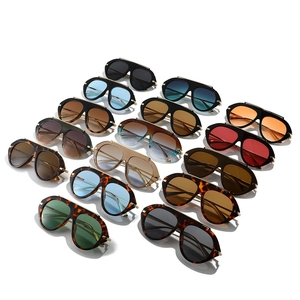 Variety of oversized pilot sunglasses with gold metal hinges and colorful lenses