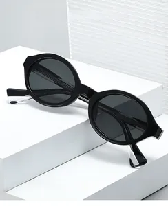 Detail of vintage oval black glasses frames shown on geometric white steps display