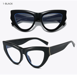 Detail view of black oversized cat eye glasses frame with elegant gold metal hinge accents