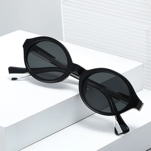 Retro oval black sunglasses for women featuring premium acetate frames and gray lenses